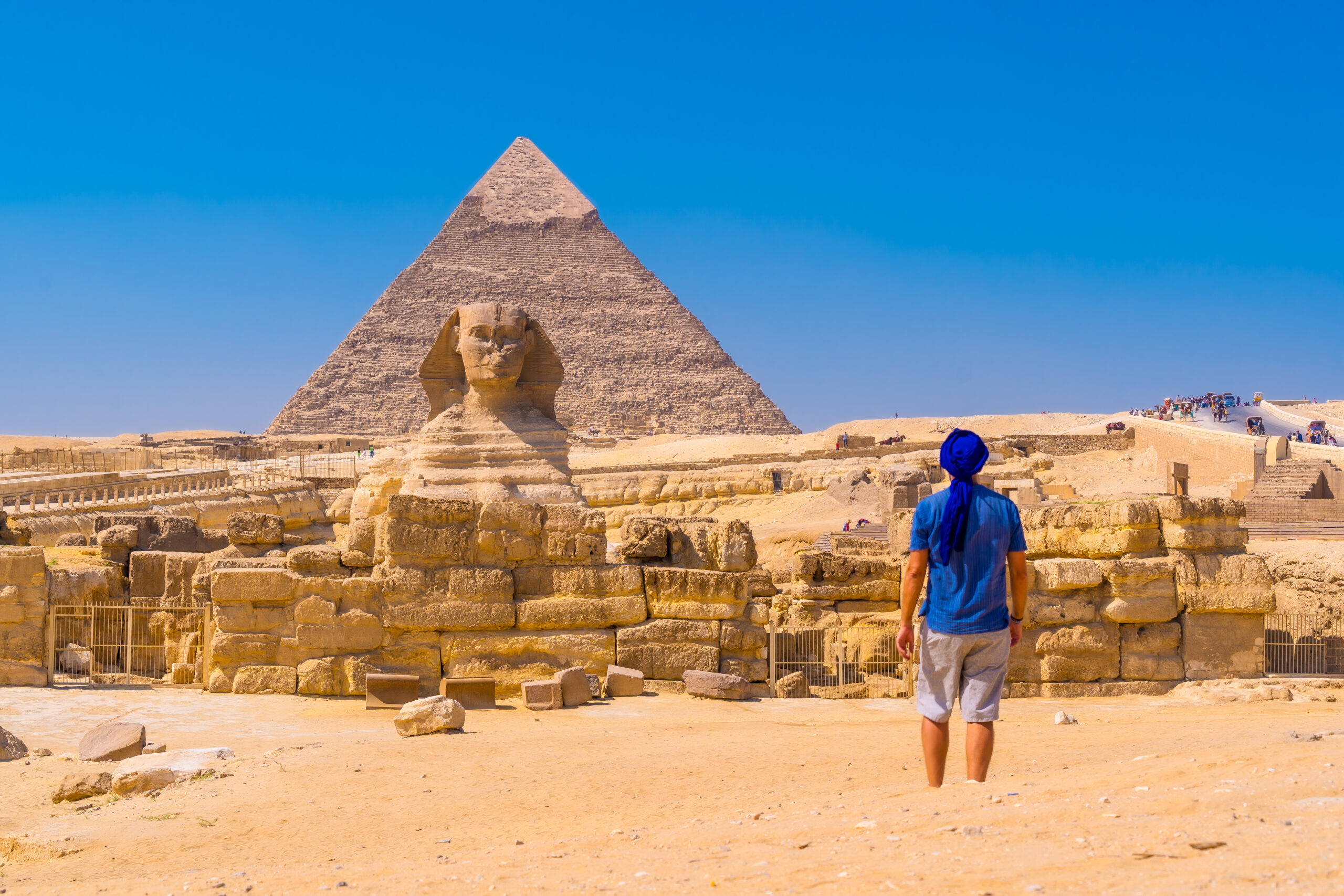 young-man-walking-towards-great-sphinx-giza-scaled.jpg